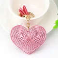 Elegant pink rhinestone heart-shaped keychain with decorative tassel and gold ring - Gold Tone + Pink