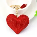 Elegant red rhinestone heart-shaped keychain with matching tassel and gold ring hardware - Gold + Bright Red