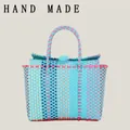 Handmade color-block woven plastic tote bag in light blue and pink for beach vacation. - Lake Blue