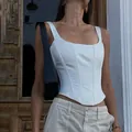 Detail view of a white fishbone corset top with a square neck and sexy style. - XS / White