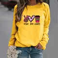 Yellow women's long sleeve sweatshirt featuring stylish Peace Love Coffee graphic print - Yellow