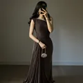 Close-up of an elegant sleeveless brown evening gown with sophisticated pleated details - XS / Coffee