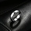 Close-up macro shot of a 6mm polished silver stainless steel ring on black leather surface - US 5 / 6mm Plain / Steel