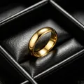 Close-up of a 6mm gold-finished 316L titanium steel plain ring in a black jewelry box. - US 5 / 6mm Plain / Gold