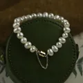 Elegant white pearl bracelet with a golden magnetic clasp and safety chain detail. - 7# Bracelet Magnetic Safety Chain Style / Pearl White