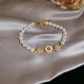 Elegant French style pearl bracelet with golden evil eye zircon charms on silk fabric - 52# Bracelet Evil Eye Starburst Style / Gold Pink