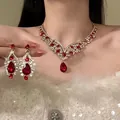 Vintage royal style jewelry set with red waterdrop rhinestones on elegant Asian model. - 4# Necklace and Earrings / Gold And Red