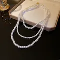 Elegant triple-strand white pearl necklace with golden clasp for a French chic look - White Triple Layer Wrap
