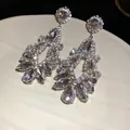 Elegant silver drop earrings featuring geometric teardrop crystal tassel design - Silver