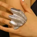 Close-up detail of an artistic irregular pleated silver knuckle ring with texture - Left Hand / Silver