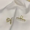 Elegant gold-tone butterfly pearl ear cuff for non-pierced ears on white satin fabric - Streamlined Pearl Ear Cuff (61)