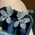 Exquisite silver needle sparkling diamond flower stud earrings presented in a blue velvet box - Silver
