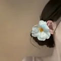 Elegant white fabric flower hair clip with blue gradient petals on model - Alligator Clip - Blue Yellow