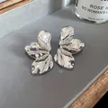 Elegant silver crumpled metal petal stud earrings with high-gloss finish for women - Silver Folded Petal Style (HE13116)