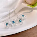 Elegant French vintage style clear flower drop earrings with sparkling blue crystal centers. - White Blue Transparent Flower Style (HE13834)