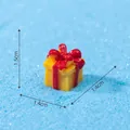 Miniature yellow resin Christmas gift box with red bow ornament measuring 1.5x1.4x1.4cm - Yellow Gift Box
