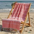 Pink striped Turkish cotton beach towel with tassels displayed on a beach lounger - 100*180CM / Orange Fine Stripes