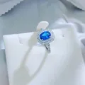 Elegant oval royal blue imitation sapphire ring featuring a shimmering halo of diamonds. - Light Blue Ring