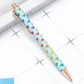 Glittery blue retractable ballpoint pen with colorful heart patterns and rose gold accents. - Light Green Heart (Rose Gold Hardware) / 1.0mm Bullet Tip