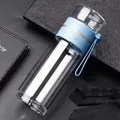 Double-wall glass tea infuser water bottle featuring a stylish light blue silicone grip - Blue 400ml