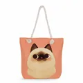 Detail view of a cartoon Siamese cat print on a peach-colored canvas beach tote bag - Orange Siamese Cat (msk1220)