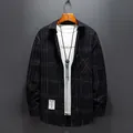 Casual men's black and white plaid long sleeve shirt in a loose fit button-up style. - Black Plaid