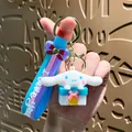 Cute Cinnamoroll cartoon character keychain sitting on gift box with blue strap - Sanrio Gift Box - Cinnamon Dog