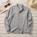 Close-up of a grey linen stand collar shirt showing fabric texture and pocket detail - Dark Gray