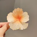 Close-up of a gradient hibiscus flower hair claw clip with textured petals - 8cm Large Size / Candied Orange