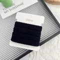 Durable high elastic black seamless hair ties for ponytail styling on display card - Solid Black