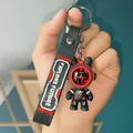 Close-up of astronaut bear keychain with 'Explore Future' printed strap - Roaming Four-Section Chain Style / Red