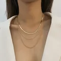 Detailed view of a trendy layered gold snake chain and twist necklace set on a model - Stacked Snake Blade Chain and Double Twisted Rope Chains (04 Gold) / Gold