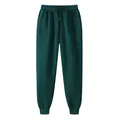 Dark green fleece-lined sweatpants with drawstring and elastic waist for men and women. - Dark Green