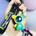 Cute space astronaut bear keychain charm in green and yellow with printed black strap - Roaming Sitting Bear / Green