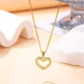 Macro detail of gold-plated heart pendant encrusted with cubic zirconia - Hollow Heart Style (X-045) / Gold