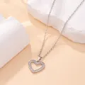 Close-up detail of a sparkling silver heart pendant necklace with tiny embedded crystals. - Hollow Heart Style (X-045) / Silver