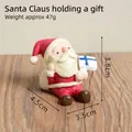 Miniature resin Santa Claus figurine holding a gift box for Christmas home decor - Santa With Gift (31)
