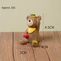 Cute miniature brown resin bear figurine holding a red apple for home and garden decor - Apple Bear (58)