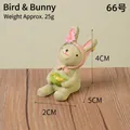 Handcrafted cute resin rabbit figurine holding a bird for home and garden decor - Bunny With Bird (66)