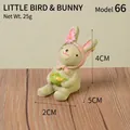 Handcrafted cute resin rabbit figurine holding a bird for home and garden decor - Bunny With Bird (66)