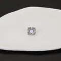 Close-up view of French style stainless steel flower stud earring with shell inlay - Four-leaf Flower Style / Steel