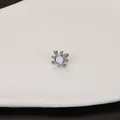 Macro view of a stainless steel stud earring with a sunburst design and shell inlay - Radiant Style / Steel