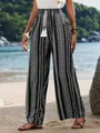 Detailed view of women's casual wide-leg pants featuring a black and white geometric print. - S / Black