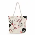 Close-up of high-capacity canvas tote bag with red stethoscope and medical prints - Red Stethoscope & Sphygmomanometer Style (ms4544)