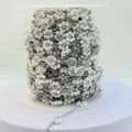 Detailed view of handmade white pearl flower chain on spool for DIY jewelry projects - Steel Color Artificial Pearl White