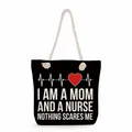 Close-up of black canvas tote bag with Mom and Nurse heart monitor print design. - Black Tribute Mom & Nurse Style (ms4556)