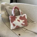 Cute pink and white cow print plush handbag featuring soft faux fur for stylish women. - Pink Cow Print