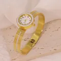 Detailed view of a fashion gold-tone stainless steel bangle watch with elegant crystals. - Greek Meander Style (B01750)