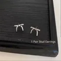 Exquisite silver-toned bow knot stud earrings for a minimalist and elegant jewelry look - Butterfly Knot (925 Sterling Silver Earring Post)