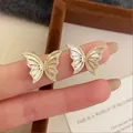 Elegant butterfly stud earrings with white inlay and shimmering rhinestones in gold finish. - Golden Mother-of-Pearl Butterfly (925 Sterling Silver Earring Post)